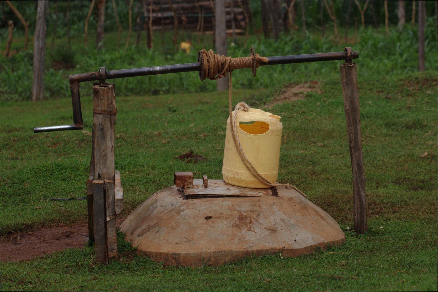 Covered hand-dug shallow well with a windlass and jerrican on a rural homestead in Kitale, Kenya